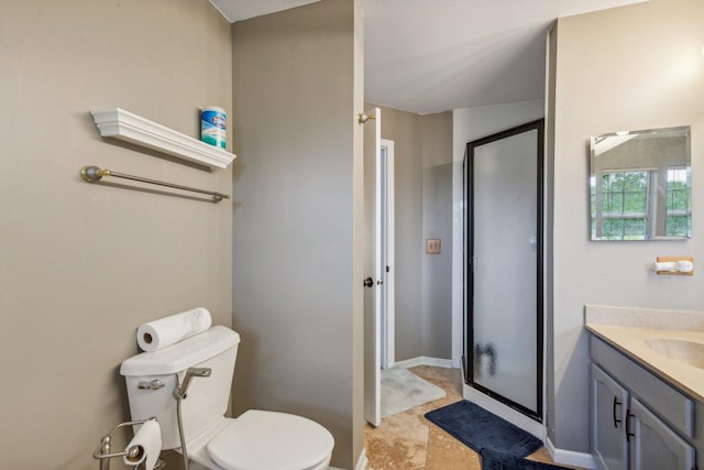 full bath featuring baseboards, toilet, a stall shower, and vanity