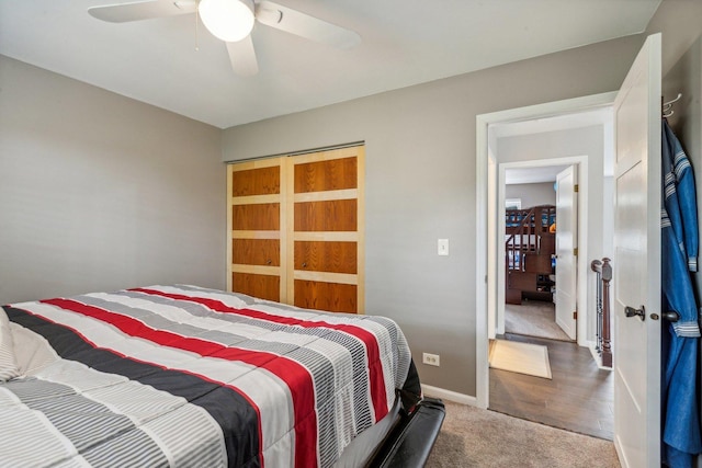 bedroom with a ceiling fan, baseboards, and carpet floors