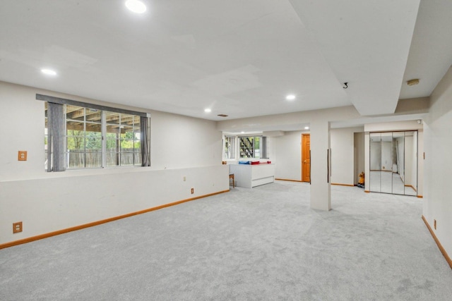 basement featuring light carpet, recessed lighting, and baseboards