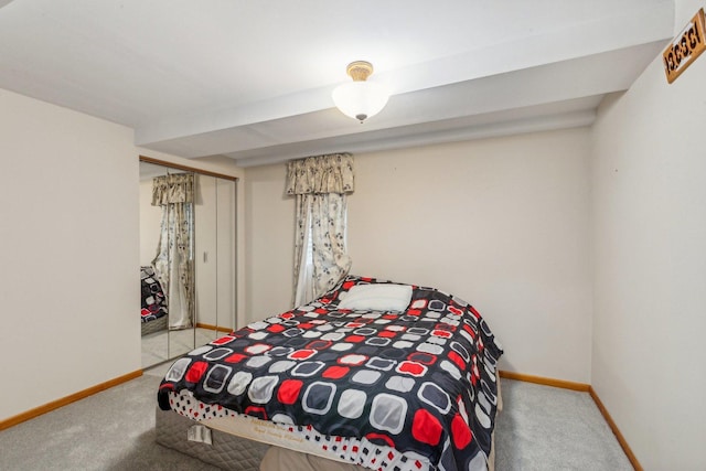 bedroom with carpet, baseboards, and a closet