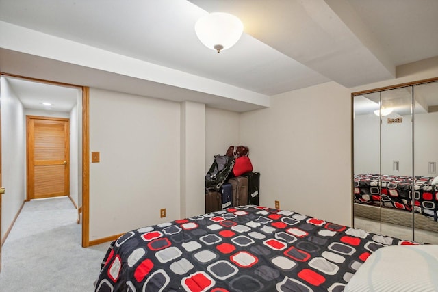 bedroom with a closet, baseboards, and carpet