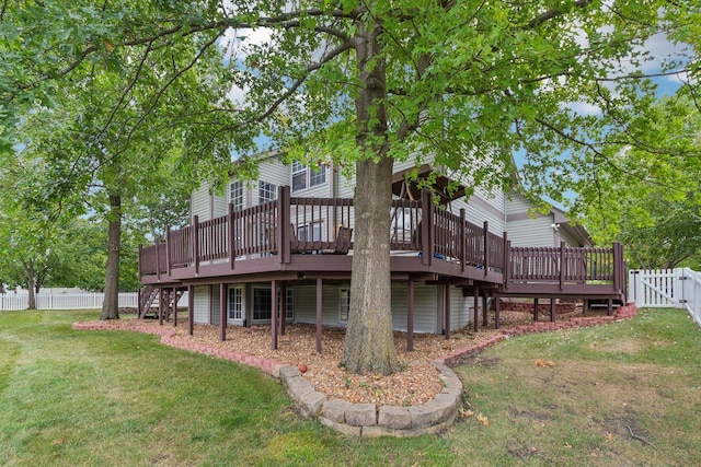 rear view of property with a lawn, a gate, a fenced backyard, a wooden deck, and stairs