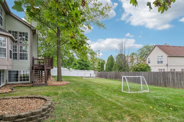 view of yard featuring stairs, a deck, and fence