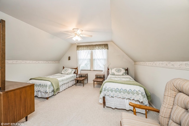 bedroom with vaulted ceiling, ceiling fan, and carpet floors