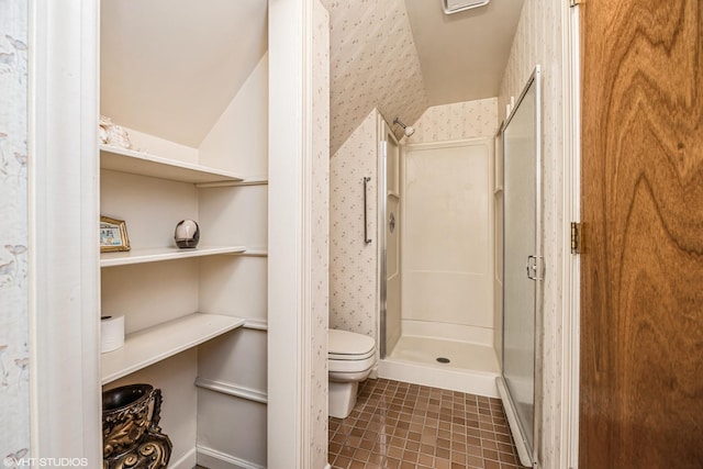 full bath with wallpapered walls, a shower stall, toilet, and tile patterned flooring