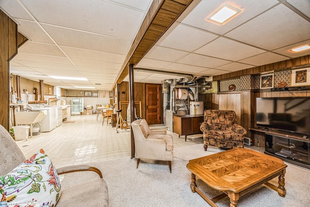 living area with washing machine and dryer, carpet floors, and a paneled ceiling