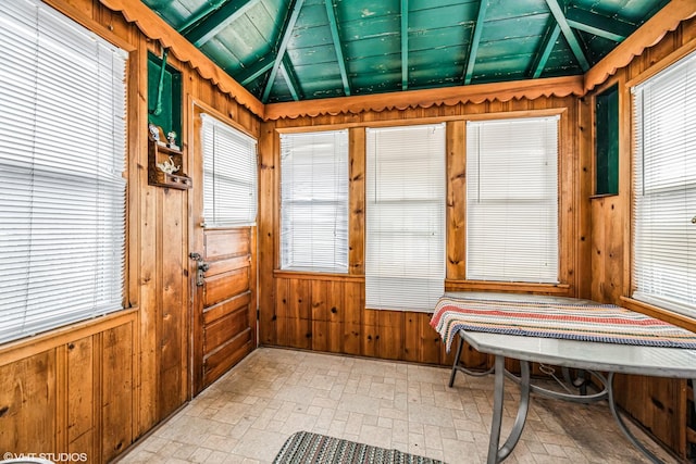 sunroom featuring wood ceiling and vaulted ceiling with beams