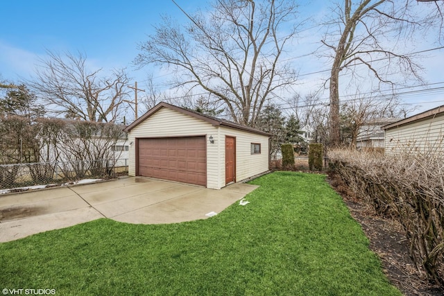 detached garage featuring fence