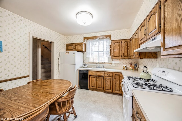 kitchen featuring under cabinet range hood, a sink, white appliances, brown cabinetry, and wallpapered walls