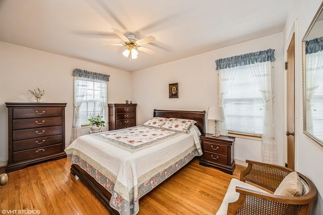 bedroom with light wood-style flooring and a ceiling fan