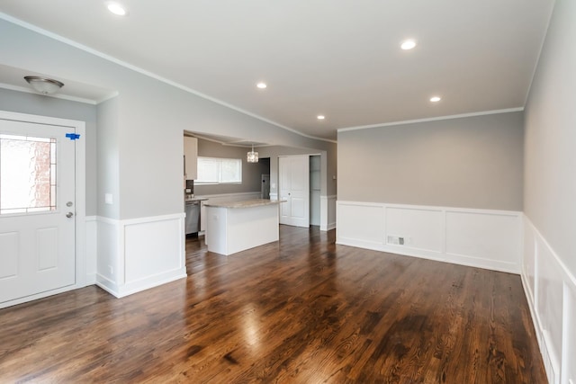 unfurnished living room featuring wainscoting, recessed lighting, a healthy amount of sunlight, and dark wood-type flooring