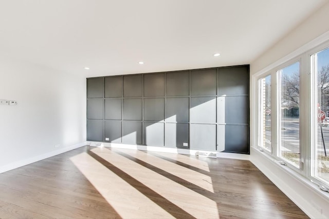 interior space with recessed lighting, wood finished floors, and baseboards