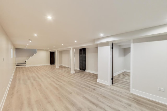 finished basement featuring recessed lighting, light wood-style floors, and baseboards