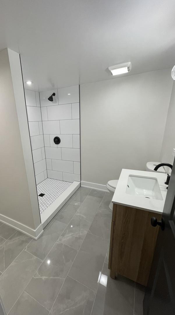 bathroom with vanity, baseboards, walk in shower, toilet, and marble finish floor