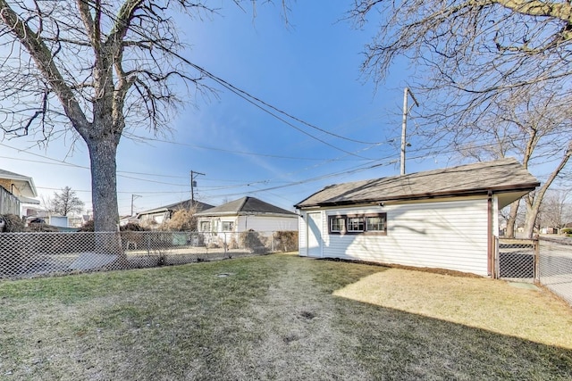 rear view of house featuring a fenced backyard and a yard