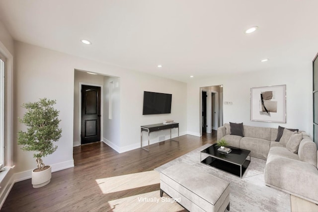 living room with recessed lighting, baseboards, and wood finished floors