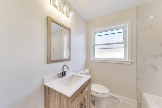 full bath featuring visible vents, toilet, marble finish floor, baseboards, and vanity