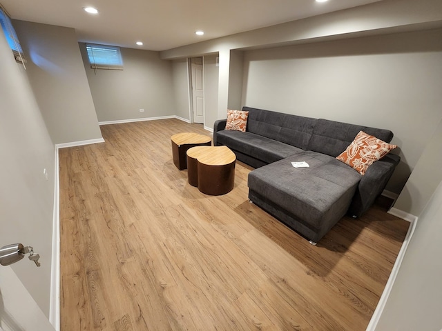 living room with recessed lighting, baseboards, and wood finished floors