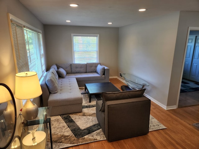 living room with plenty of natural light, recessed lighting, baseboards, and wood finished floors