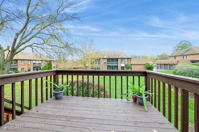 deck featuring a lawn and a residential view