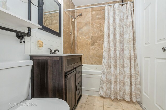 full bath featuring vanity, toilet, shower / tub combo, and tile patterned flooring