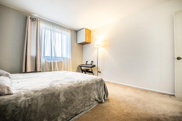 carpeted bedroom with baseboards