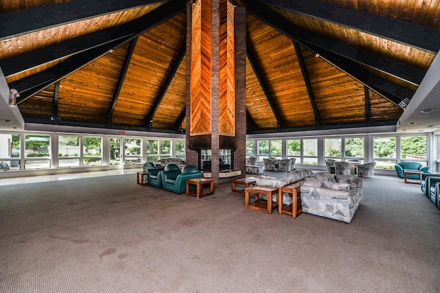 unfurnished living room with wooden ceiling, beamed ceiling, carpet, and a healthy amount of sunlight