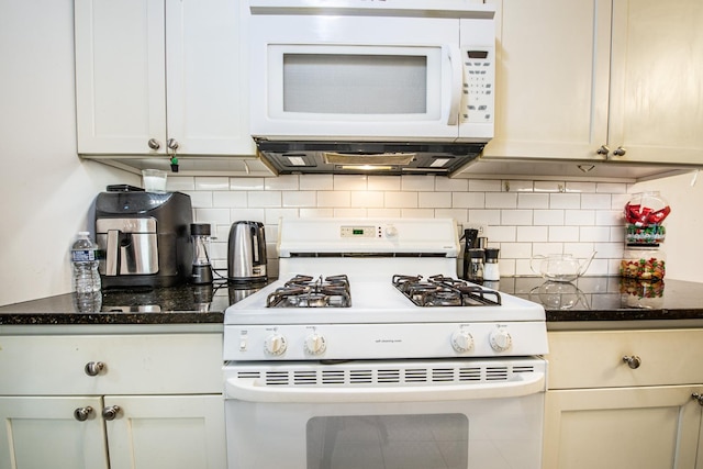 kitchen with tasteful backsplash, white appliances, and dark stone counters