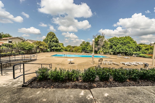 pool featuring a patio area and fence