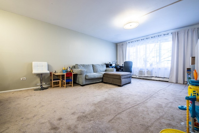 carpeted living area with a baseboard radiator