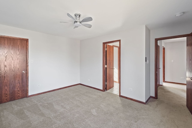 unfurnished bedroom with carpet flooring and baseboards