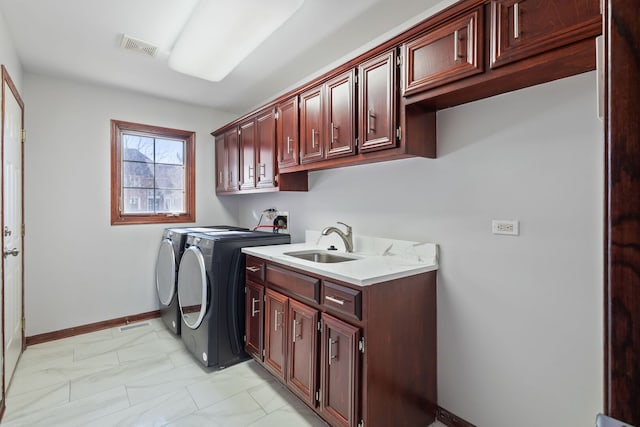 washroom with visible vents, cabinet space, a sink, washing machine and dryer, and marble finish floor