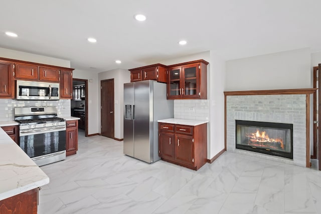 kitchen with dark brown cabinets, glass insert cabinets, recessed lighting, appliances with stainless steel finishes, and marble finish floor