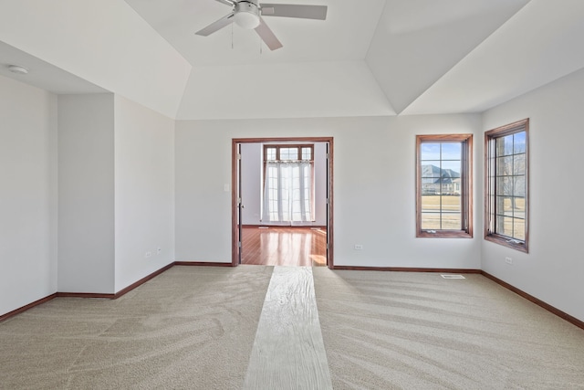 spare room featuring plenty of natural light, baseboards, carpet, and a ceiling fan