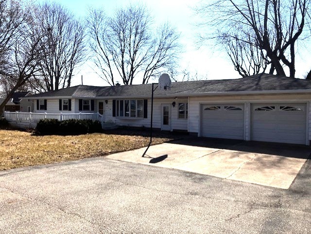 ranch-style home featuring concrete driveway and a garage