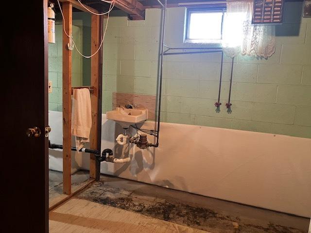 below grade area with a sink