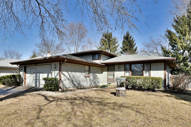 view of front of home with a front yard and a garage