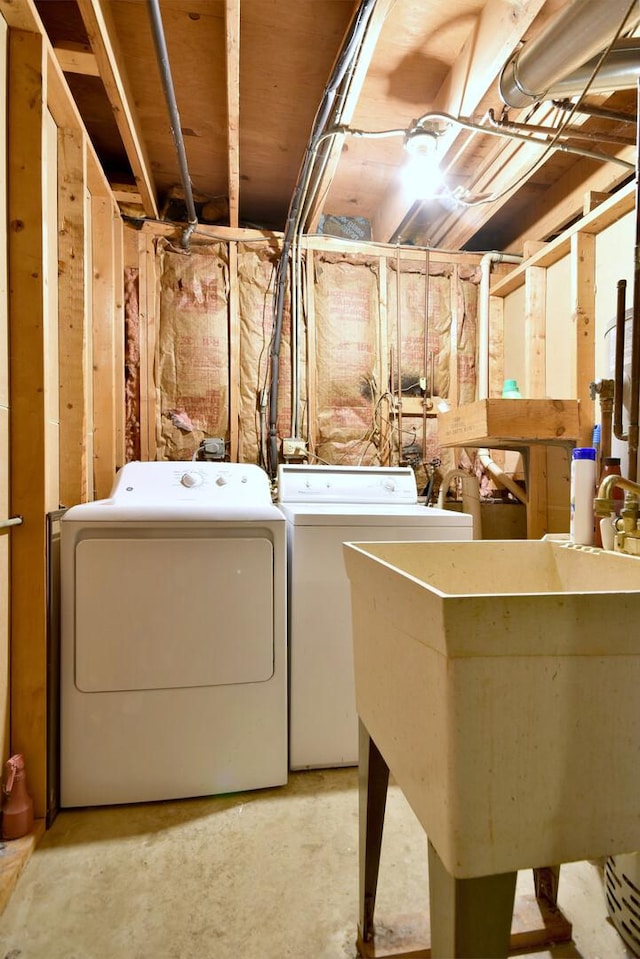 laundry area featuring a sink, laundry area, and washer and clothes dryer