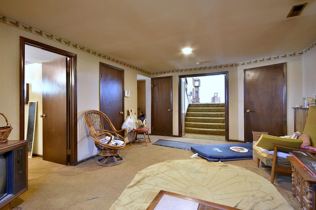 carpeted bedroom with visible vents and wallpapered walls