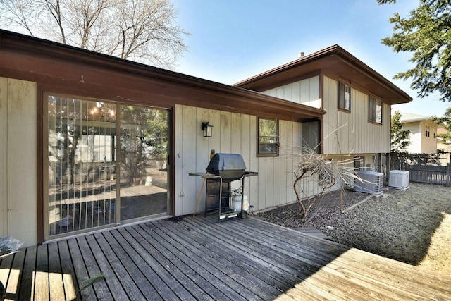 deck featuring central air condition unit, fence, and grilling area