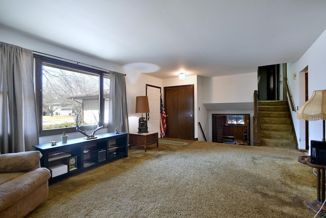 living area featuring stairway and carpet floors