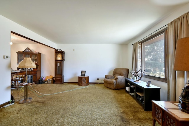 sitting room featuring baseboards and carpet