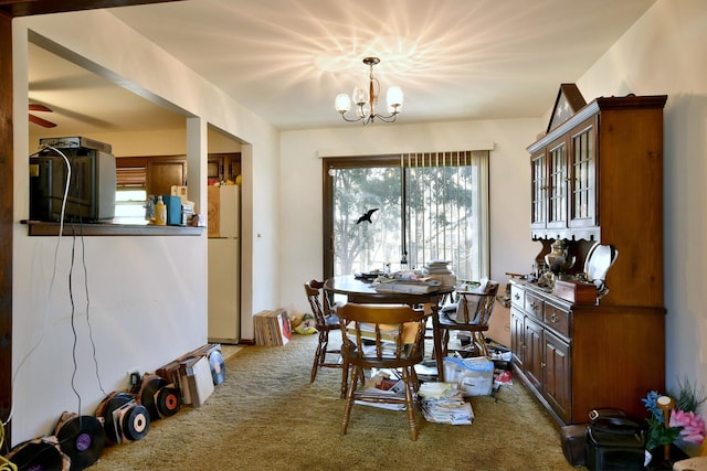 carpeted dining area featuring a notable chandelier