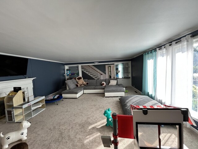 carpeted living area with stairway