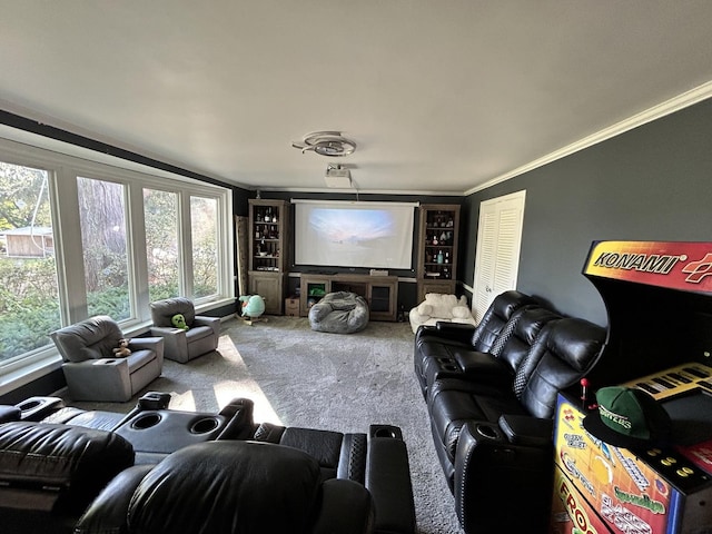 carpeted home theater featuring crown molding