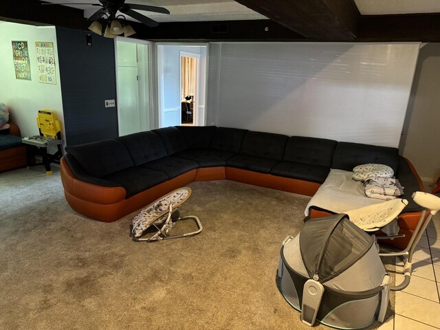 carpeted living room featuring tile patterned floors and a ceiling fan