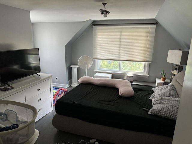 bedroom with baseboards and vaulted ceiling