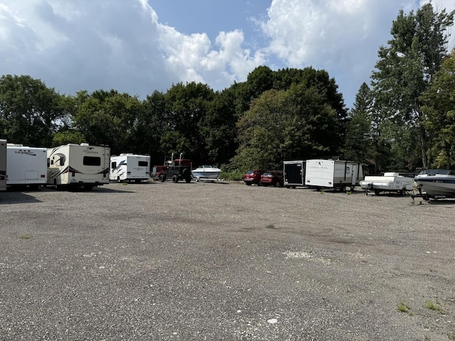 view of parking / parking lot featuring mail area