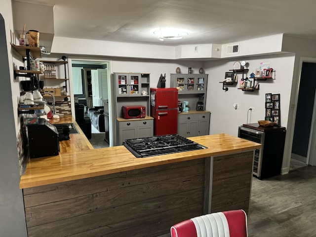 kitchen with visible vents, open shelves, wood counters, and wood finished floors