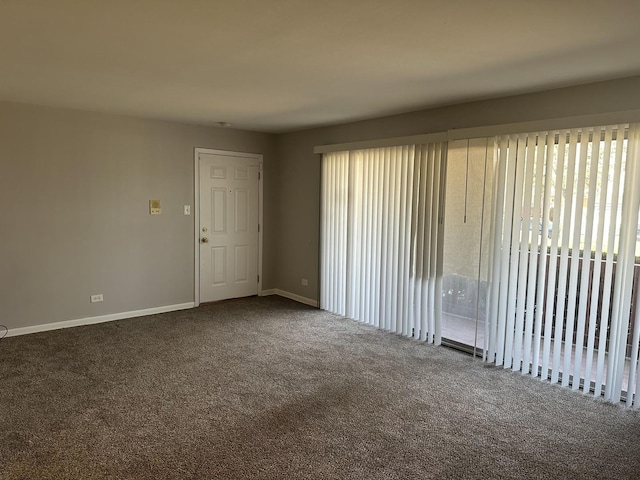 carpeted empty room with baseboards